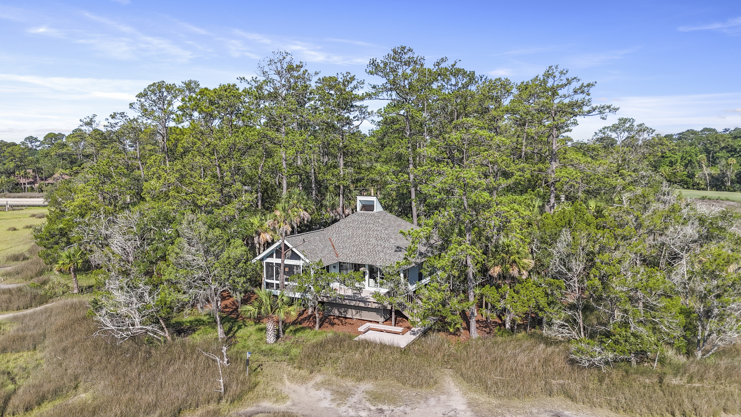 Marshfront retreat in Moss Creek with sweeping views, screen porch, and timeless Lowcountry charm.
