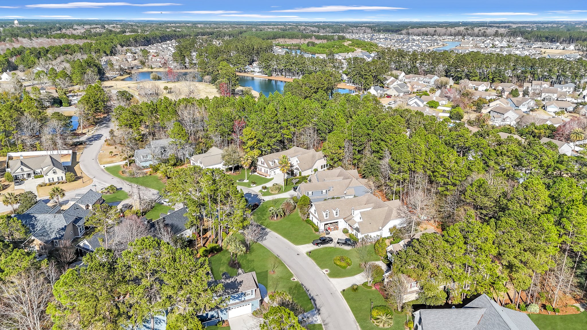 Charming street view of Old Town Bluffton with historic Lowcountry homes and oak trees draped in moss.