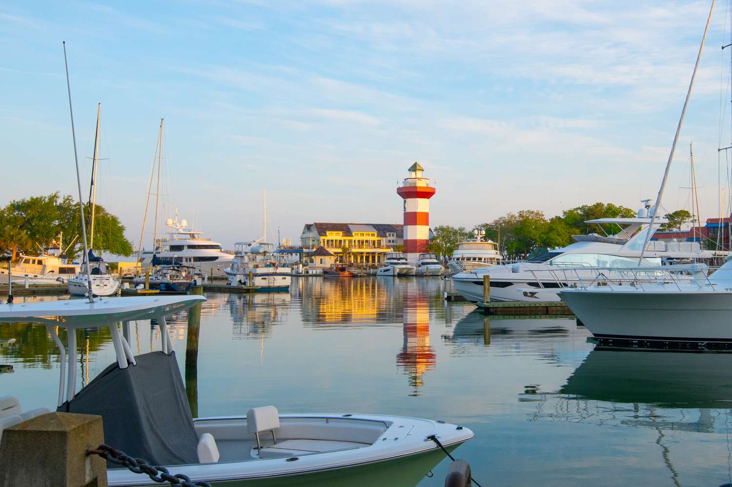 RBC Heritage golfer putting on scenic course with golden sunset and lush green fairway
